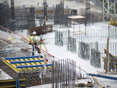 man-making-measurements-building